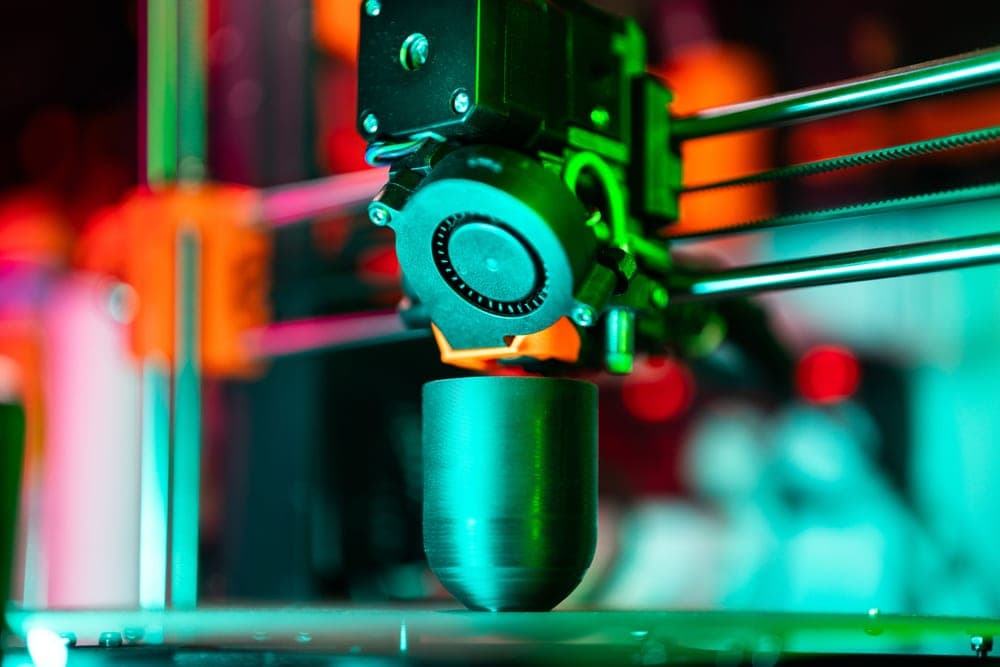 A CoreXY 3D printer toolhead moving at speed over a part
