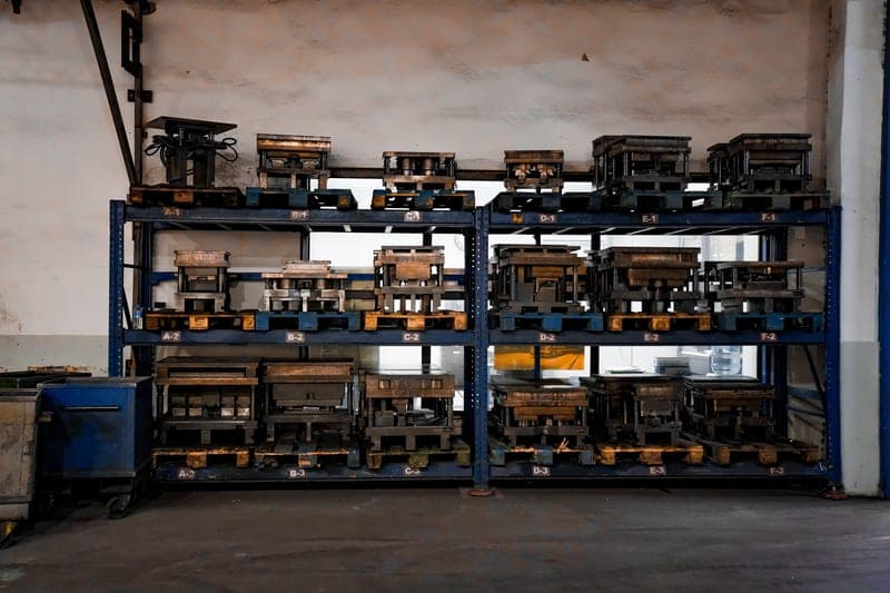 A multi-layer metal storage rack holding spools and accessories