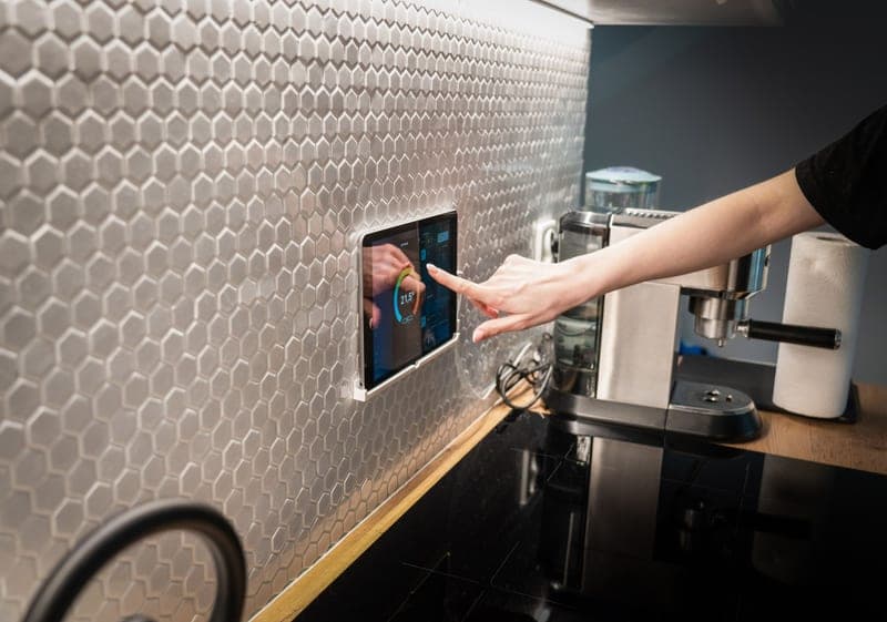 A touchscreen control module mounted on a desktop 3D printer